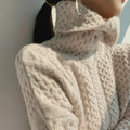 Turtleneck sweater in beige soft knit with a clean modern cut, front view.
