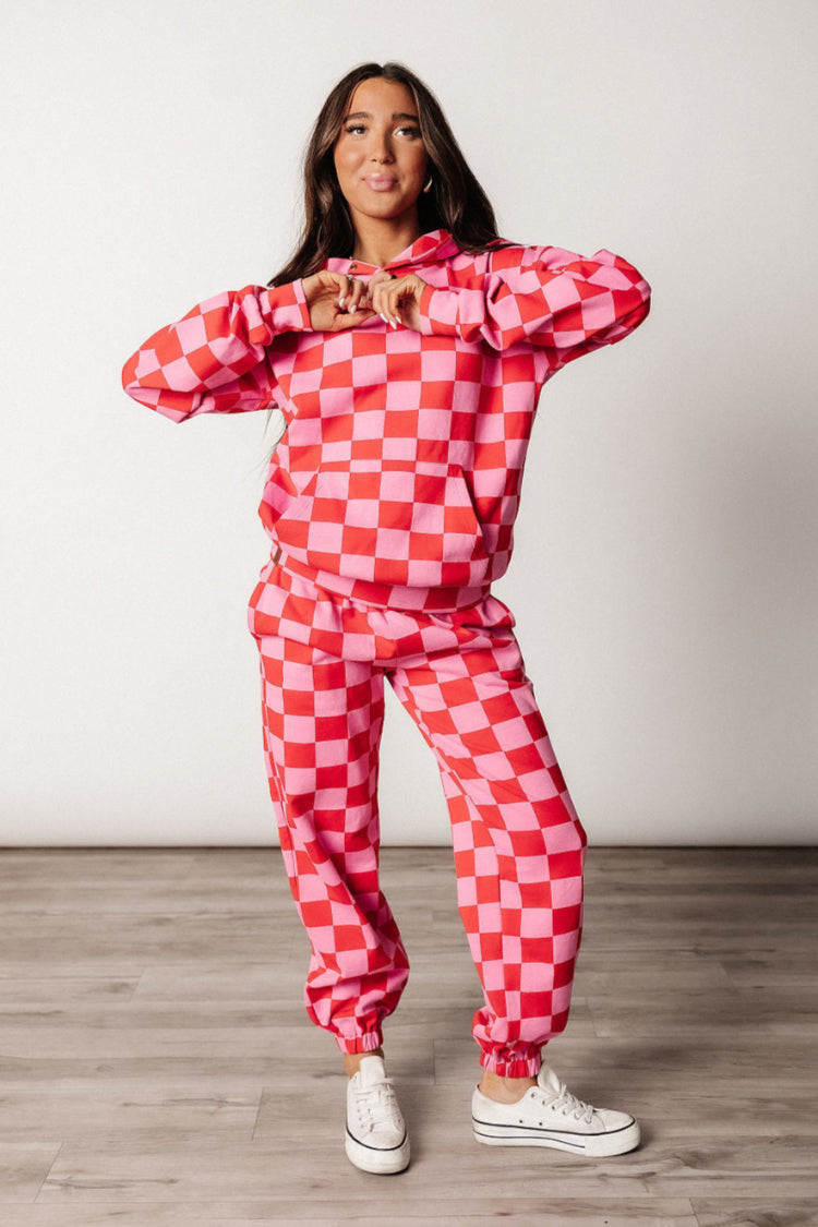 Pink and red checkered hoodie, three-quarter styled view