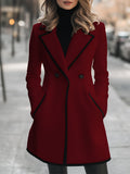Double-breasted coat with contrast trim along the edges, front view