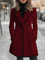 Double-breasted coat with contrast trim along the edges, front view