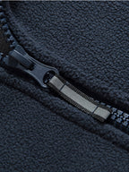 Fleece jacket in black with a high protective collar, outdoor style, front view.