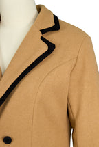 Close-up of contrast trim and button fastening on double-breasted coat