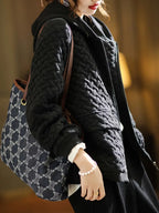 Quilted basketweave hoodie layered under a coat, styled view