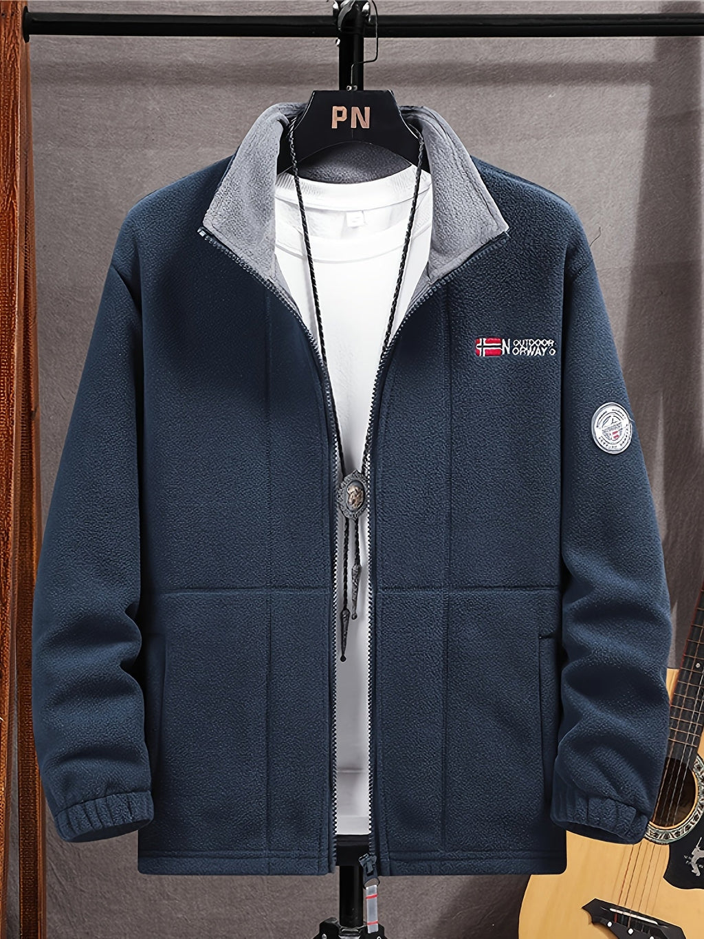 Fleece jacket in khaki with a high protective collar, outdoor style, front view.