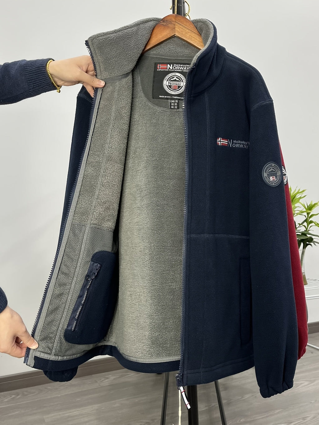 Fleece jacket in red with a high collar and lightweight build, front view.