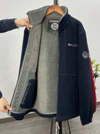 Fleece jacket in red with a high collar and lightweight build, front view.