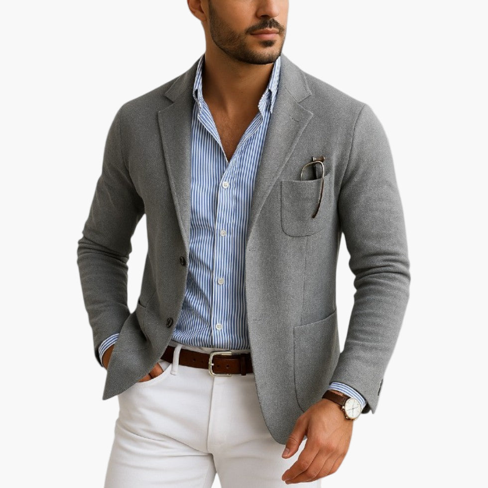 Grey tailored blazer with classic lapel and patch pockets, shown front view