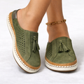 Orthopedic slip-on shoes in green with breathable perforated panels and tassel detail.