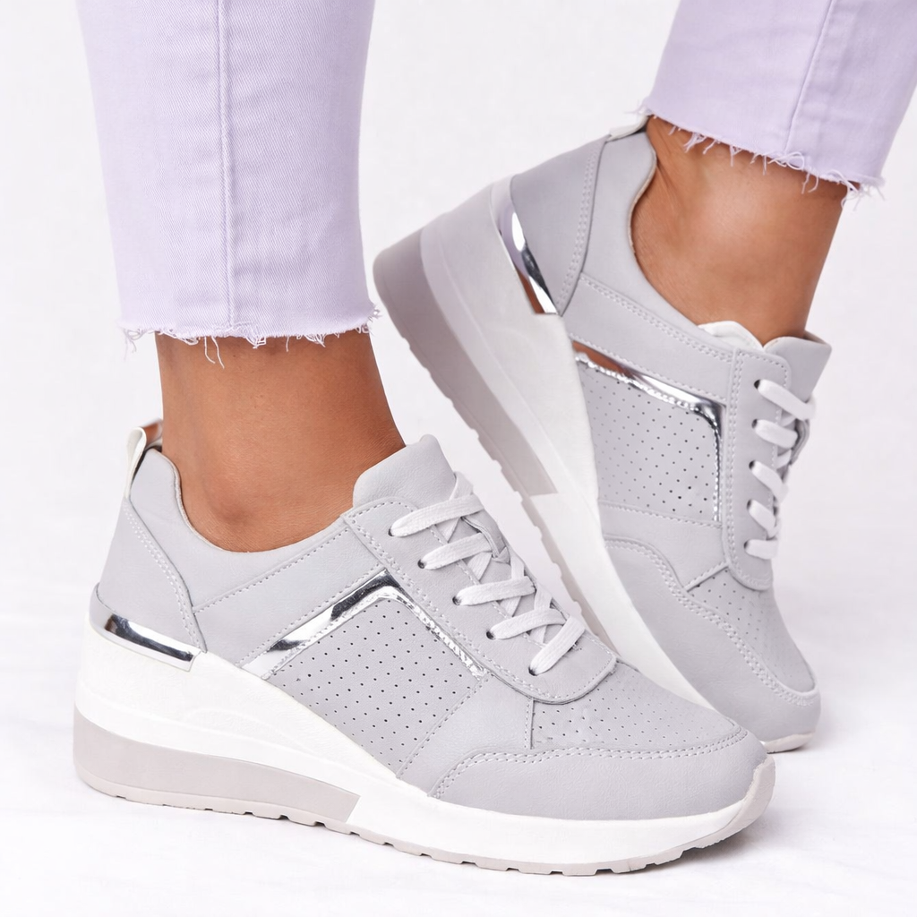 Orthopedic shoes with wedge sole in grey, breathable lace-up upper, side view.
