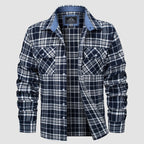 Plaid flannel shirt detail: button-down front, chest pockets and double-button cuffs.