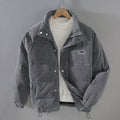 Grey padded corduroy jacket with full-zip front and deep pockets, warm winter outerwear