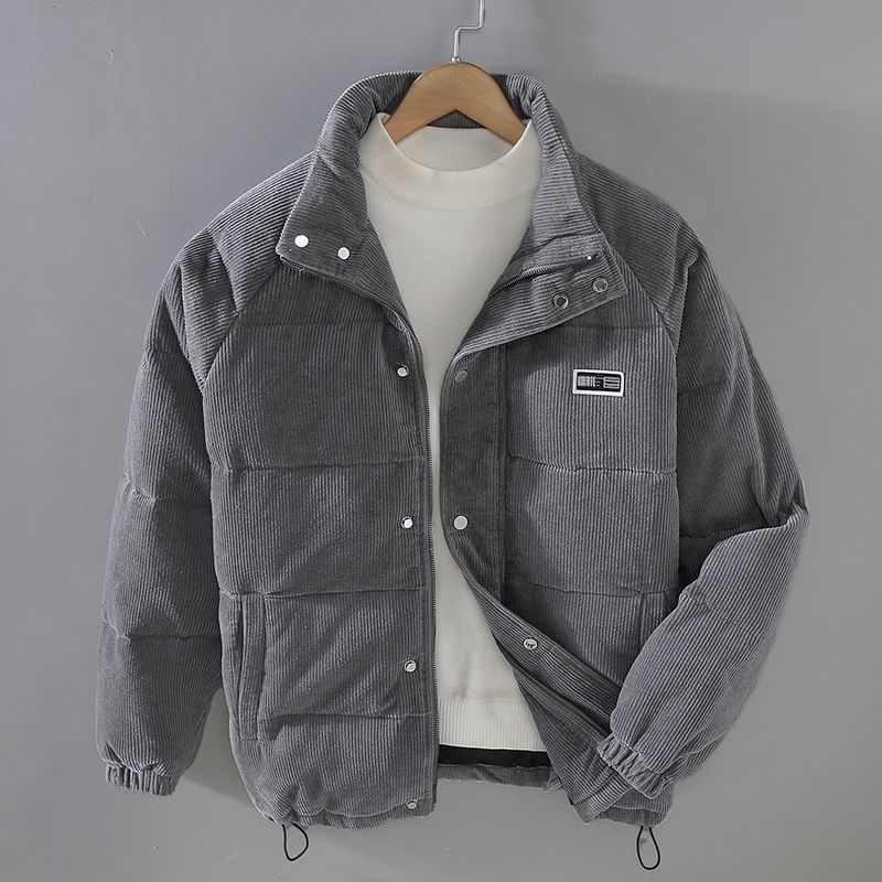 Grey padded corduroy jacket with full-zip front and deep pockets, warm winter outerwear