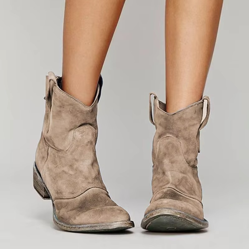 Western ankle boots in beige with pointed toe and low block heel, side view.
