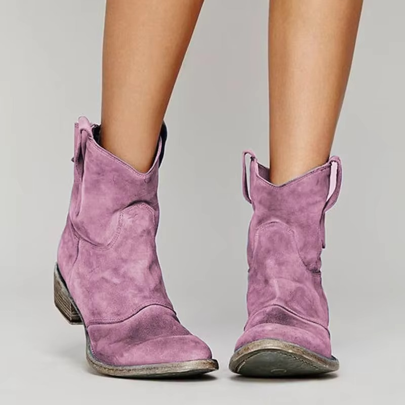 Western ankle boots in pink with pointed toe and low block heel, side view.