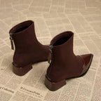 Suede-look ankle boots shown from the back with patent heel panel