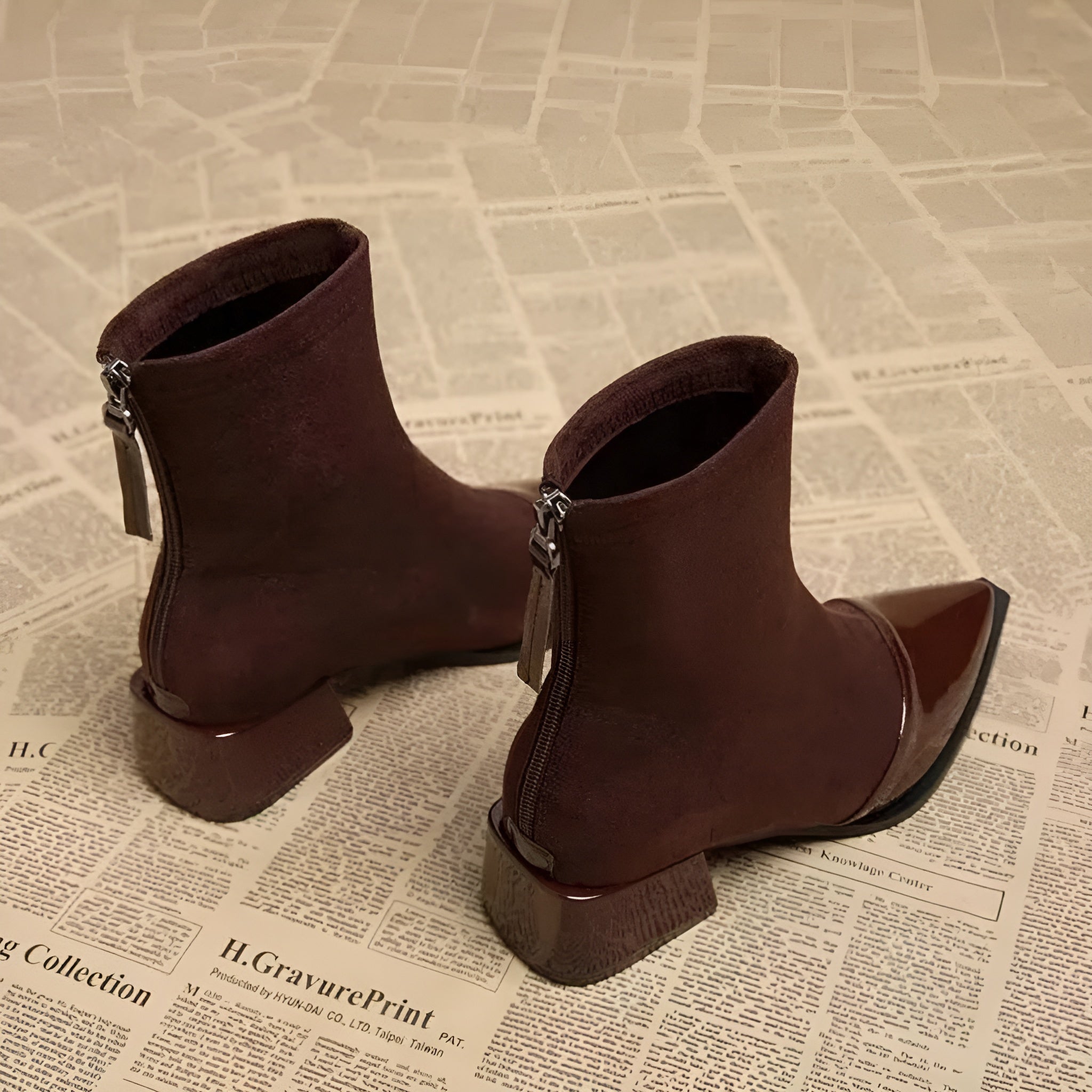 Suede-look ankle boots shown from the back with patent heel panel