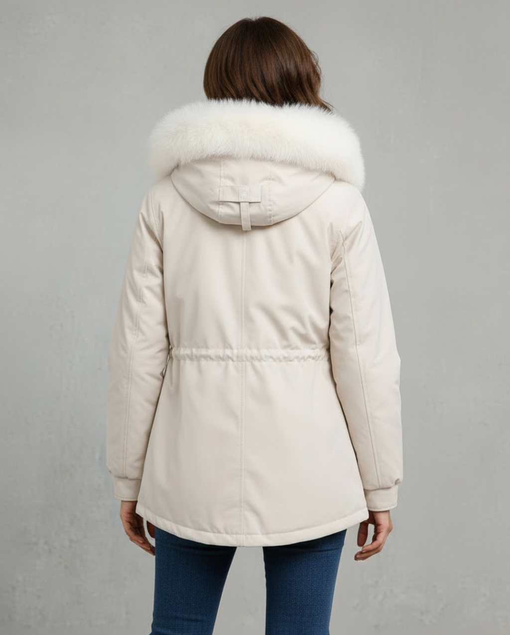 White fleece-lined parka shown worn with the hood up and high collar zipped