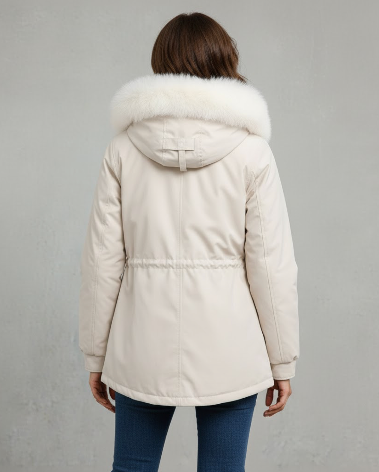 White fleece-lined parka shown worn with the hood up and high collar zipped