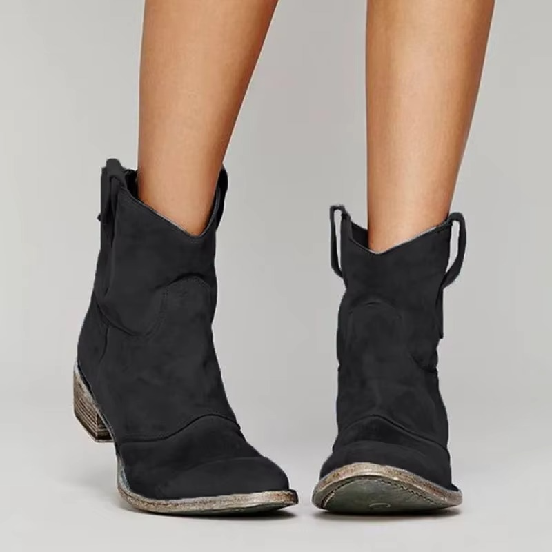 Western ankle boots in black with pointed toe and low block heel, side view.