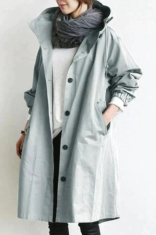 Rain coat in black with an oversized hood and wind-resistant finish, front view.