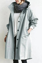 Rain coat in black with an oversized hood and wind-resistant finish, front view.