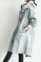 Rain coat in navy with an oversized hood, waterproof outer fabric, front view.