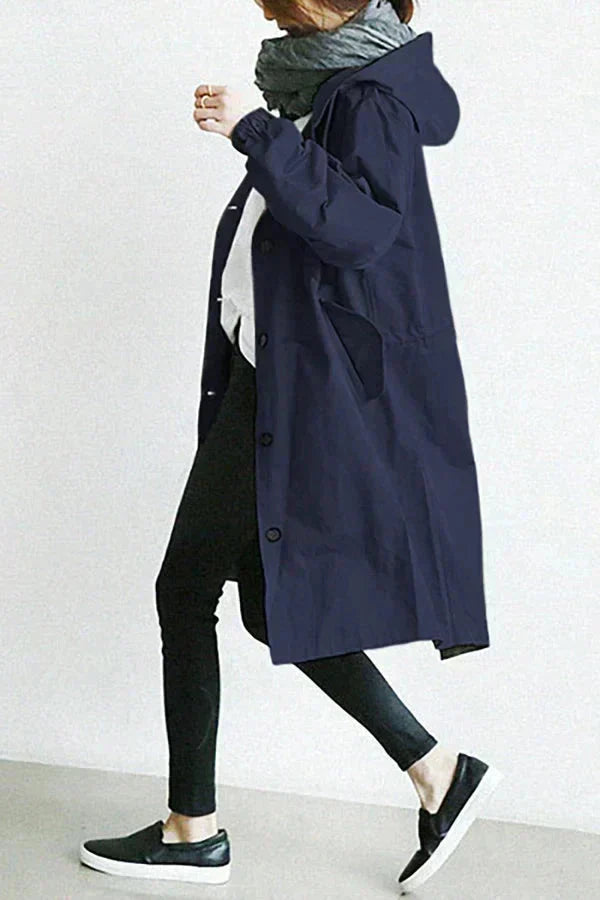 Rain coat in turquoise with an oversized hood, wind-resistant outer, front view.