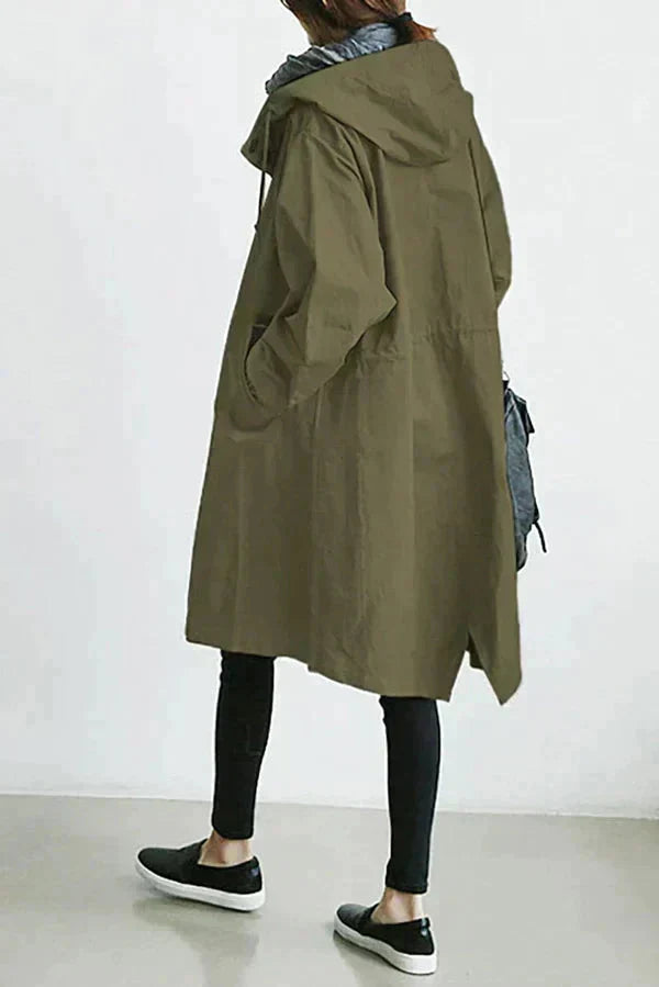 Rain coat in pink with an oversized hood and waterproof finish, front view.