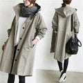 Rain coat in grey with an oversized hood and waterproof finish, front view.