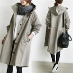 Rain coat in grey with an oversized hood and waterproof finish, front view.