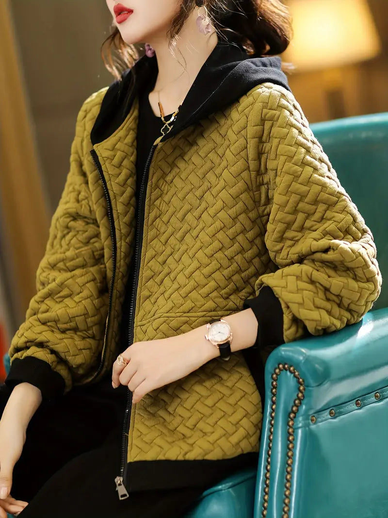Quilted hoodie with zip-up closure and side pockets, styled view