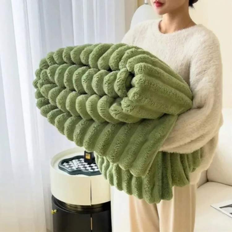 Faux-fur throw blanket in green with a striped design, shown folded