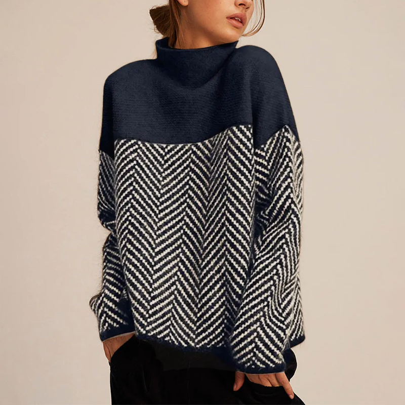 Chevron knit turtleneck sweater in blue with a relaxed fit and high collar, front view.
