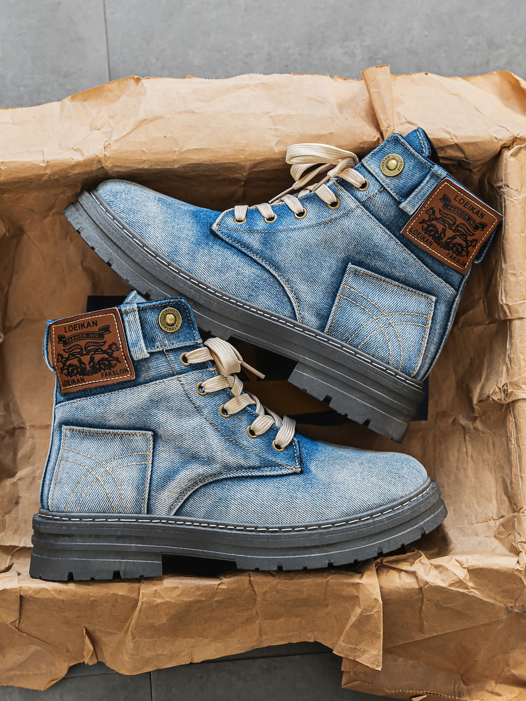 Blue washed denim boots with lace-up front and chunky sole, side view