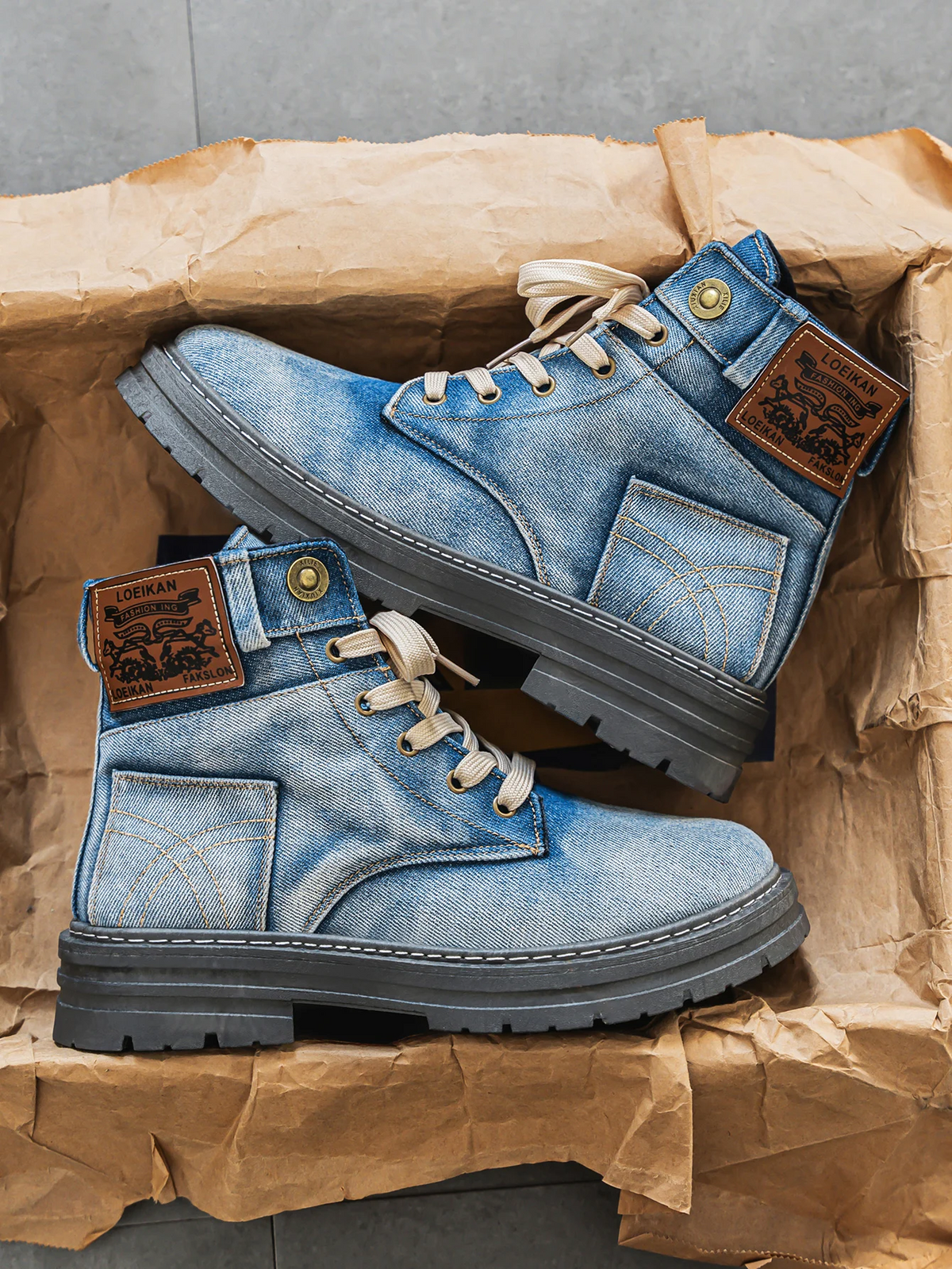 Blue washed denim boots with lace-up front and chunky sole, side view