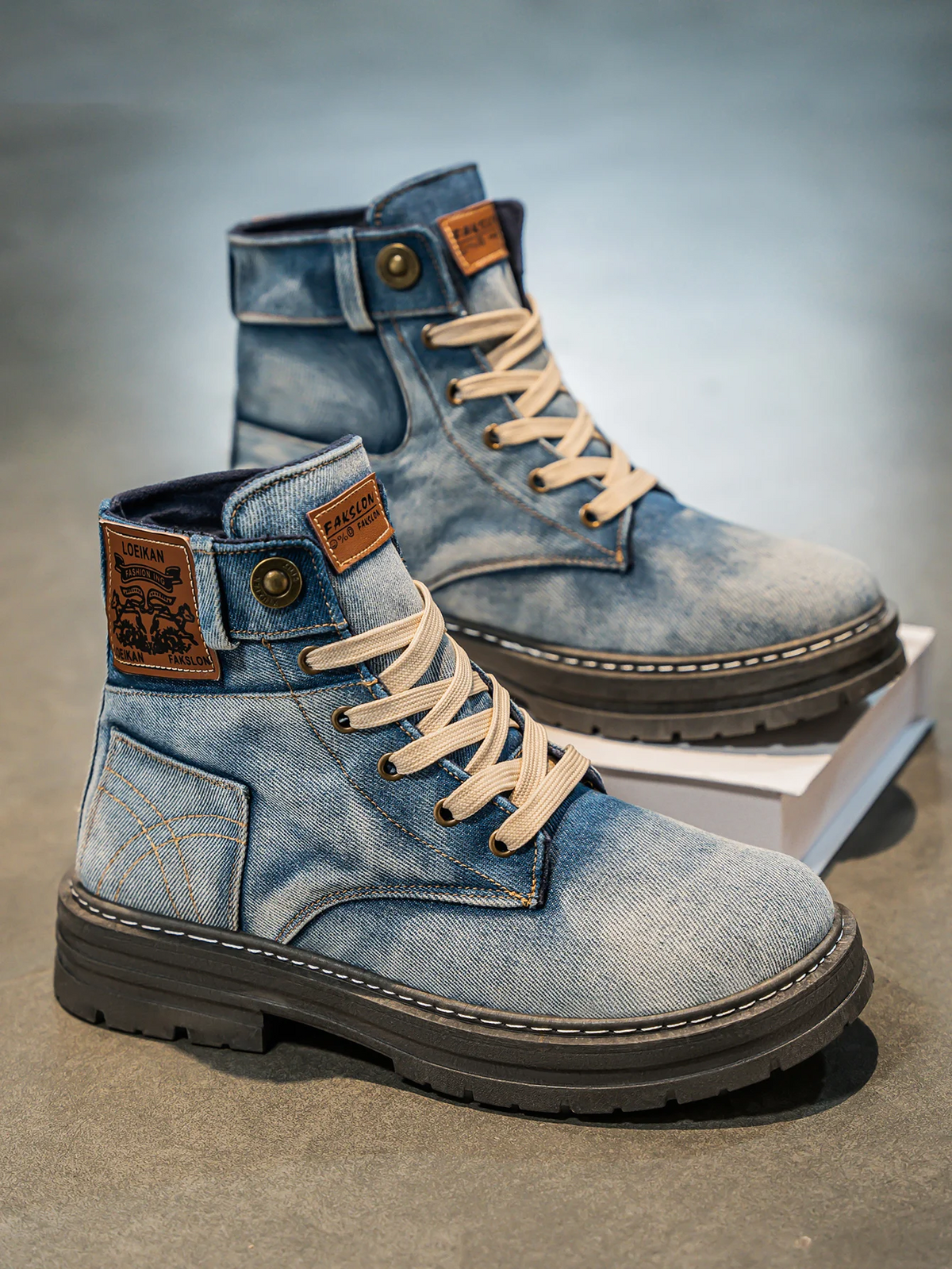 Denim boots with reinforced metal eyelets, close-up lacing detail