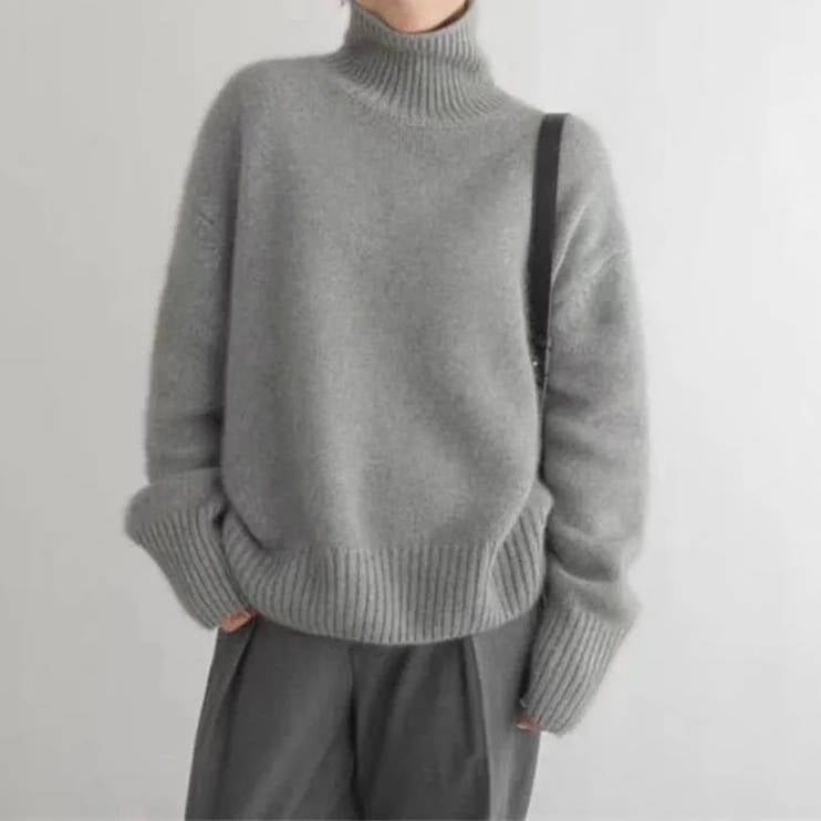 Soft knit turtleneck sweater tucked into a midi skirt