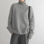 Soft knit turtleneck sweater tucked into a midi skirt