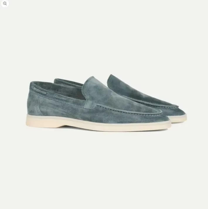 Suede yacht loafers in blue, slip-on style with hand-stitched detailing, side view.