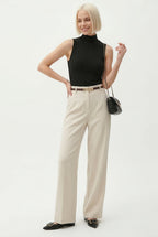 High-waist wide-leg wool trousers in white.