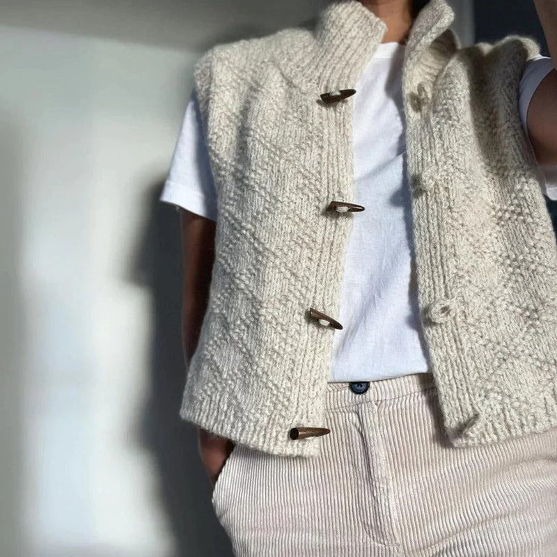 Beige structured sleeveless vest styled as a layer, side view