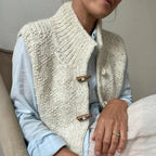 Beige structured sleeveless vest showing the hip-length hem, back view