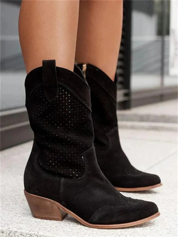 Cowboy boots in black with a mid-calf shaft and side zip, side view.