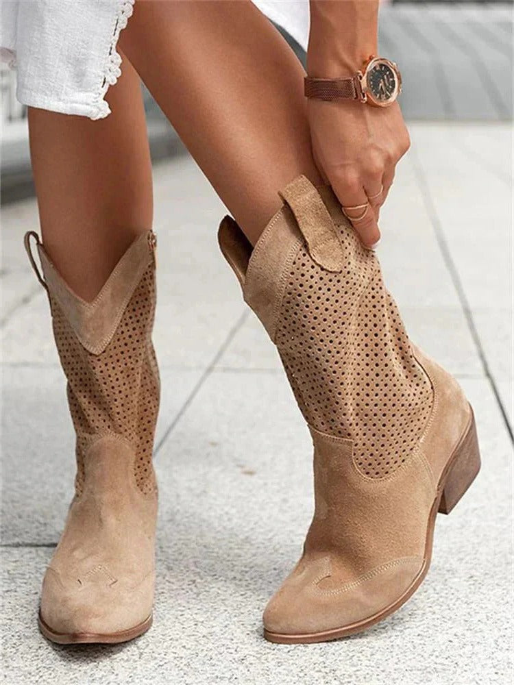Cowboy boots in brown with a mid-calf shaft and side zip, side view.