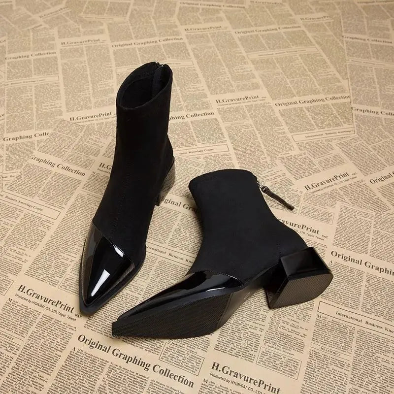 Suede-look ankle boots detail showing the glossy patent toe panel