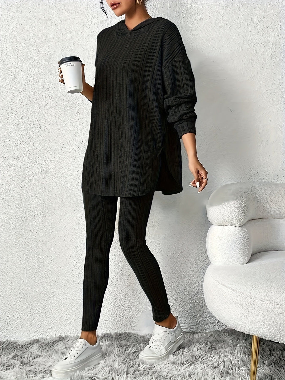 Black ribbed knit lounge set with hooded top and leggings, front view