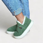Plush cushioned slippers with hard-wearing sole, side profile