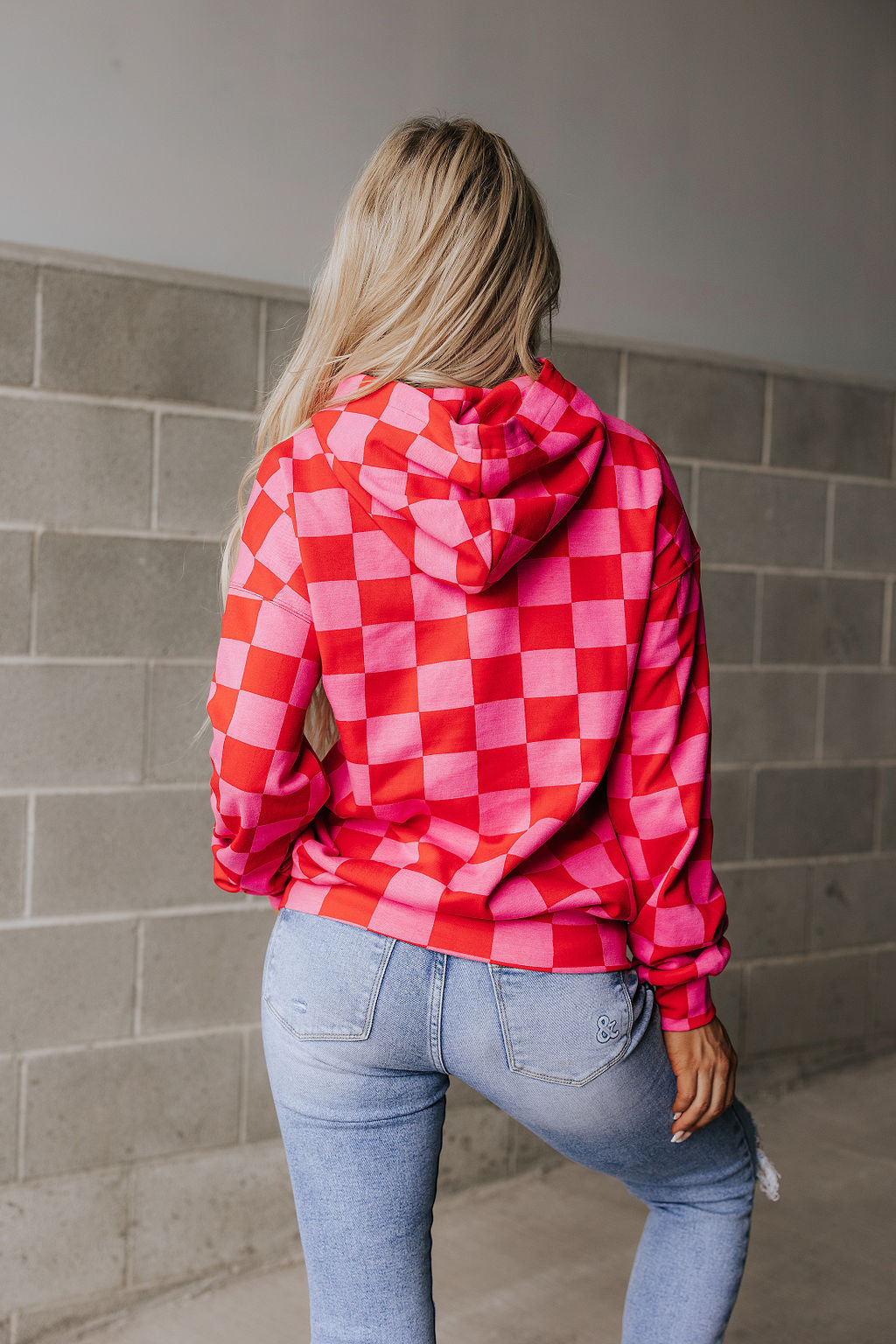 Pink and red checkered oversized hoodie, flat lay view