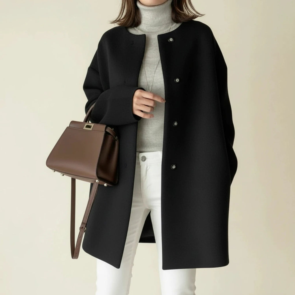 Minimalist collarless A-line winter coat in black.