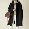 Minimalist collarless A-line winter coat in black.